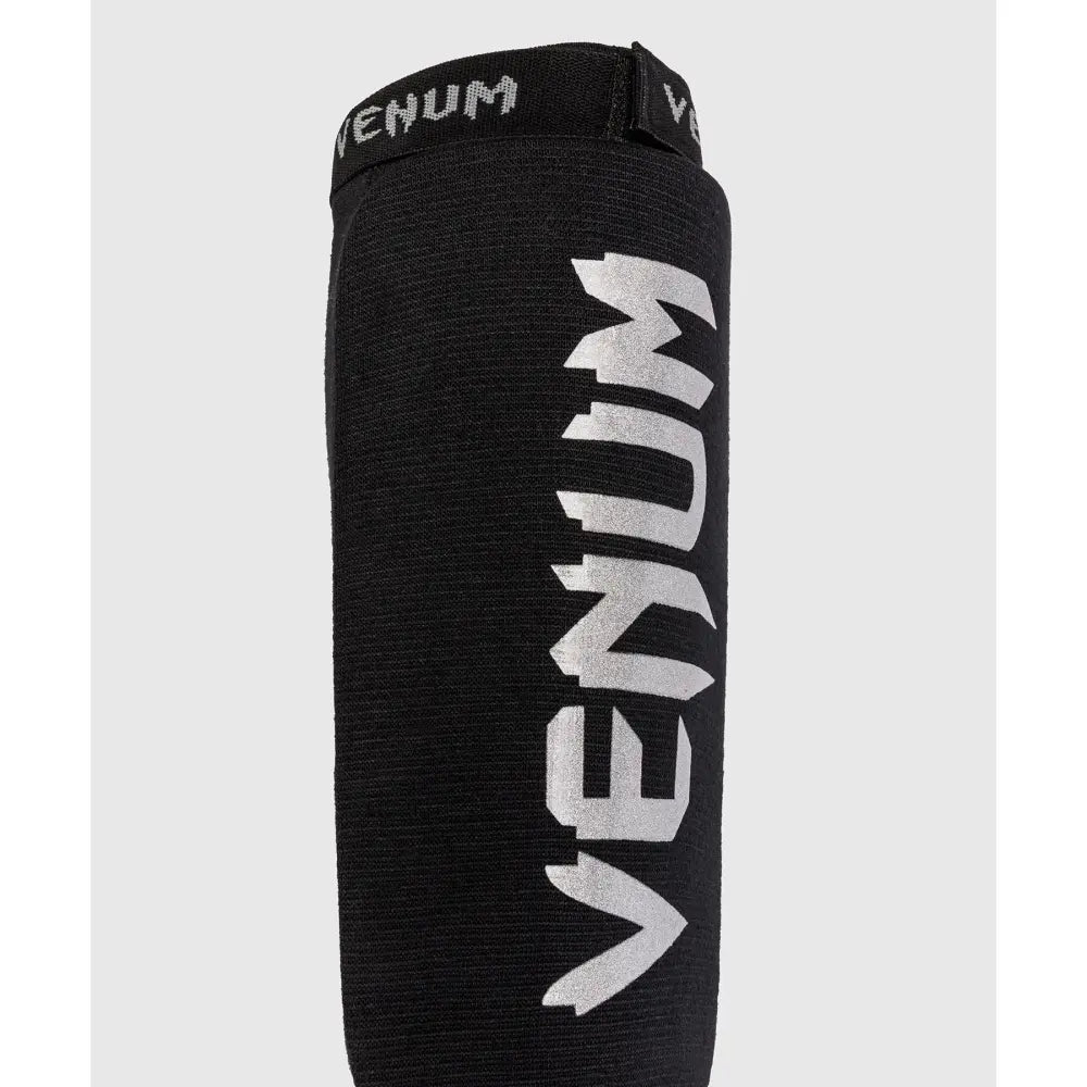 Venum logo in silver on the shin guards
