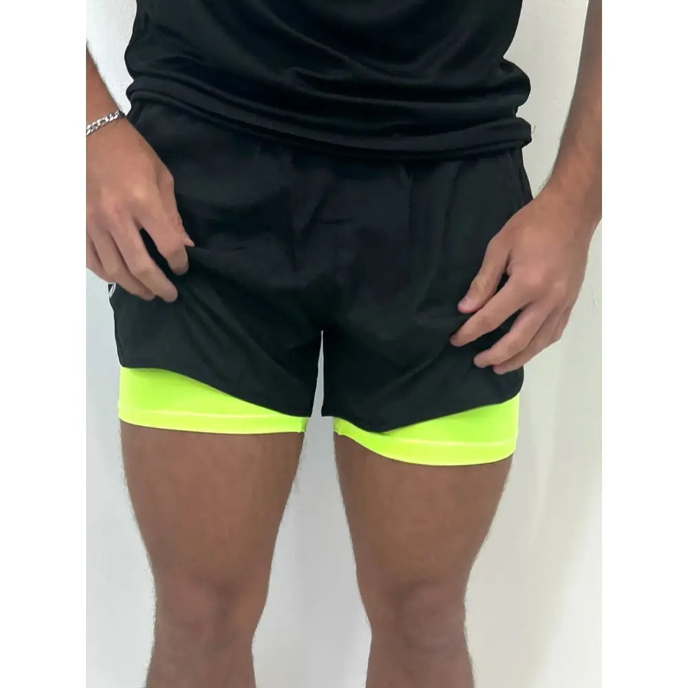 Yellow compression shorts coming out of the training shorts