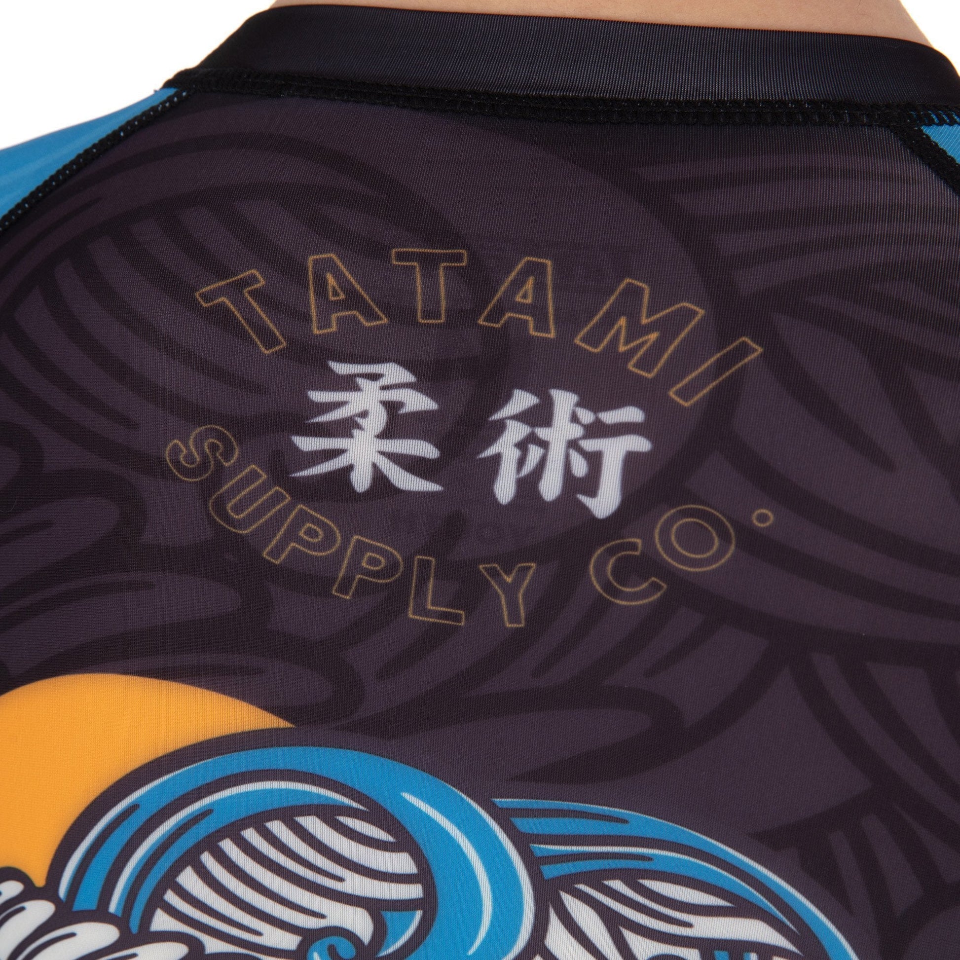 Tatami logo on the back of kids rash guard